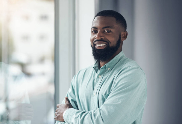 Portrait, employee and black man with arms crossed, window and corporate goals with professional and startup. Face, African person and happy consultant with career ambition and pride with confidence. - Photo, Image
