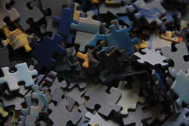 close - up of the puzzle pieces of the black jigsaw - Fotografie, Obrázek