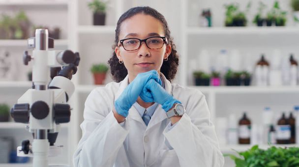 Portrait, science and woman with plants in lab, equipment for experiment and herbal medicine. Face, person and research for biotech and health with pharmaceutical testing and equipment with chemistry. - Photo, Image
