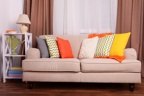 Sofa with colorful pillows in room - 写真・画像