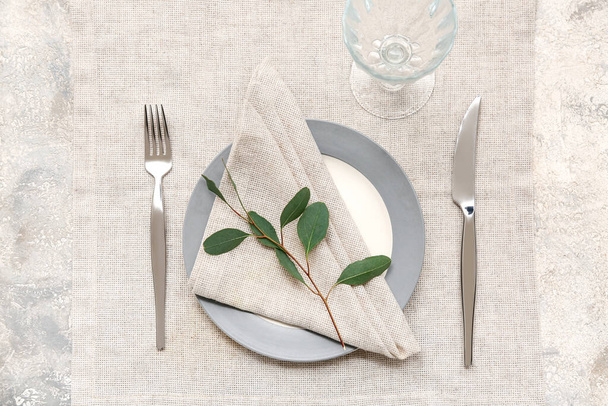 Beautiful table setting with leaves on grey background - Photo, Image