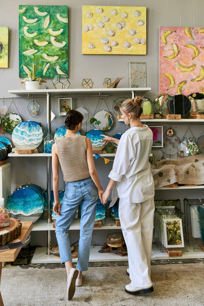 Loving, artistic lesbian couple standing together in cozy art studio. - Photo, Image