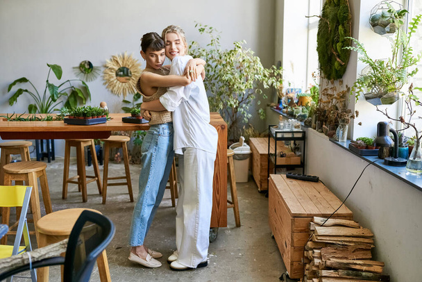 A loving lesbian couple, two women, at an art studio - Photo, Image