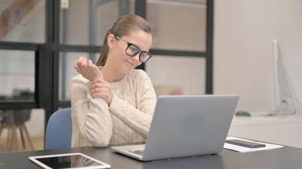 Young Woman having Wrist Pain in Office - Photo, Image
