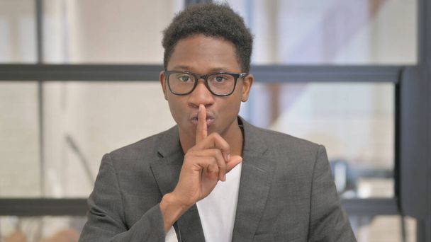 Portrait of African American Man Asking for Silence, Finger on Lips - Photo, Image