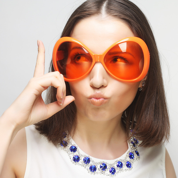 young happy woman with big orange sunglasses - Photo, Image
