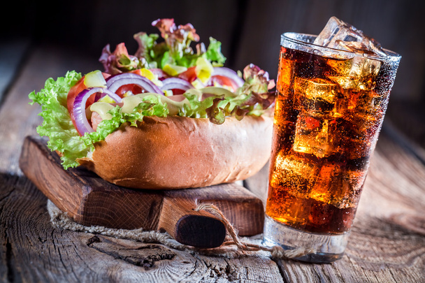 Tasty hot dog with cold drink - Foto, afbeelding