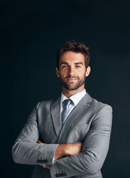 Businessman, smile and portrait in studio with suit for corporate career or professional business company. Profession, manager or formal with ambition or confident in organisation on dark background. - Photo, Image