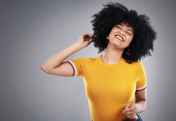 Natural, afro and woman in studio, happy and soft with shine, hair and healthy with treatment. Healthcare, aesthetic and grey background for mockup, beauty and self care for girl, pride and confident. - Photo, Image