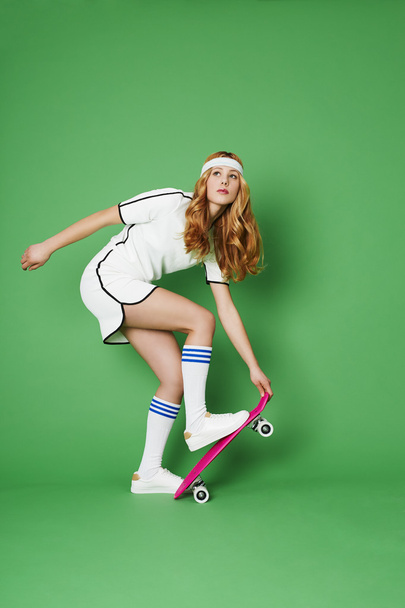 Beautiful skateboarder in studio - Valokuva, kuva