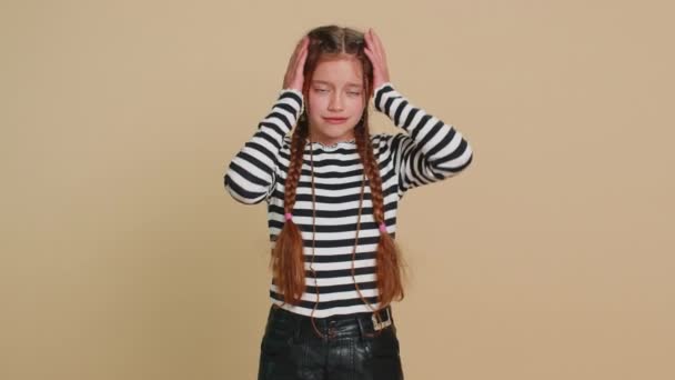 Young preteen child girl kid feeling hopelessness and loneliness, nervous breakdown, loses becoming surprised by game fail, bad fortune, loss, unlucky news. Teenager children on beige background - Footage, Video