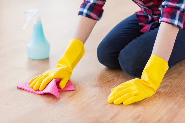 close up of woman with rag cleaning floor at home - Foto, Bild