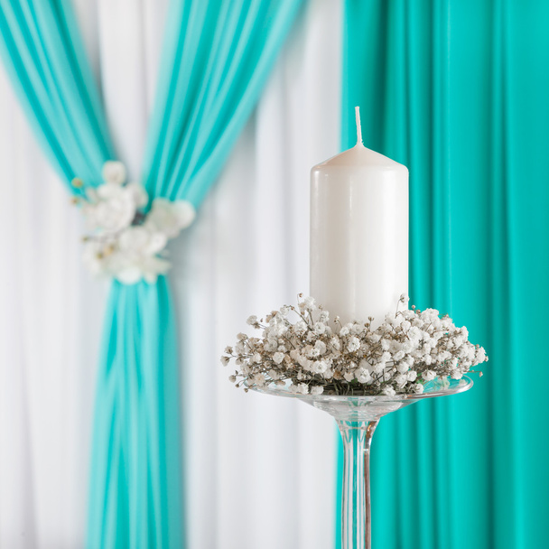 Decorated curtain and candle on candlestick. Wedding decoration. - Foto, imagen