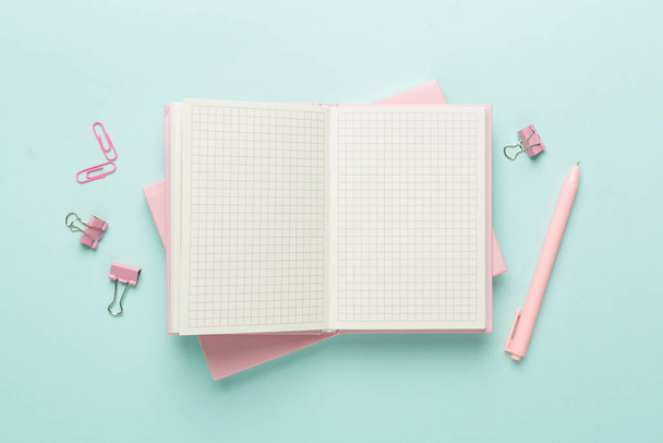 Open notebook with stationery on color background, top view - Photo, Image