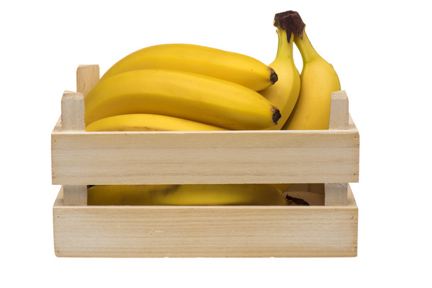 Fresh bananas in the wooden crate isolated. - Foto, afbeelding