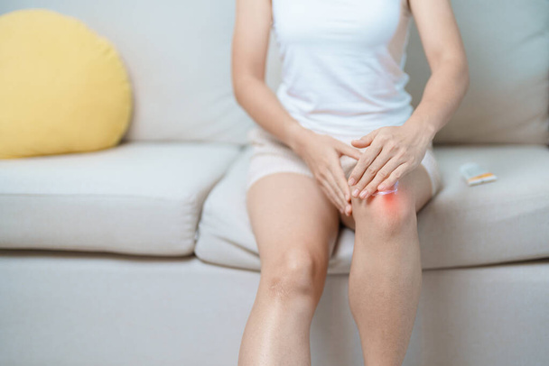 Arthritis and Muscle Pain Relief Cream concept. woman having knee ache and muscle pain due to Runners Knee or Patellofemoral Pain Syndrome, osteoarthritis, rheumatism and Patellar Tendinitis - Photo, Image