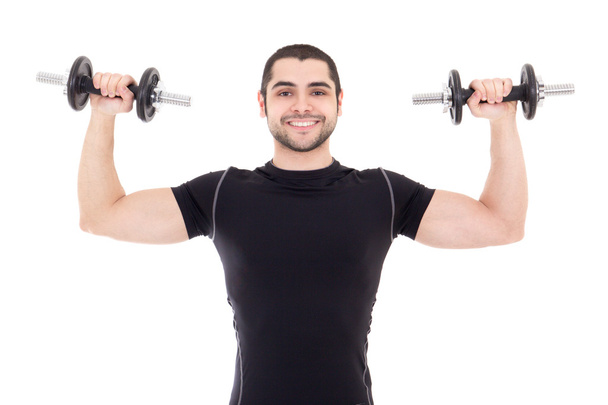 young strong man in black sportswear doing exercises with dumbbe - Foto, Imagen