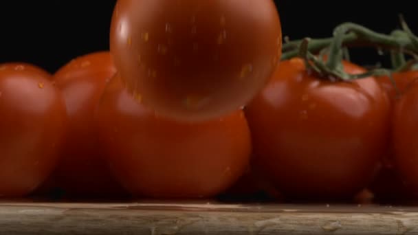 Super cámara lenta de tomate fresco golpeando mesa de madera con agua salpicada, más tomates en segundo plano a 1000 fps - Imágenes, Vídeo