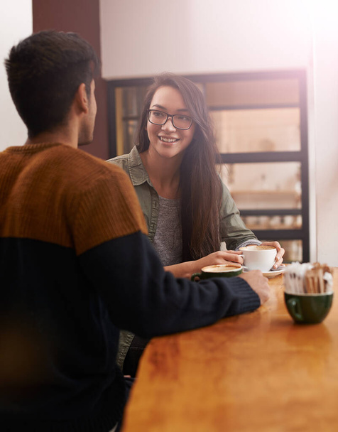 Coffee shop, love and couple on date with drink in conversation, talking and chatting for bonding. Relax, happy and man and woman with caffeine, cappuccino or beverage in restaurant, cafe and store. - Photo, Image