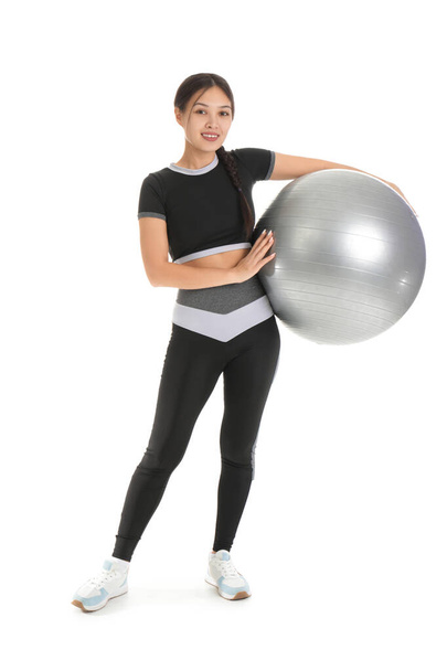 Sporty young Asian woman with fitball on white background - Photo, Image