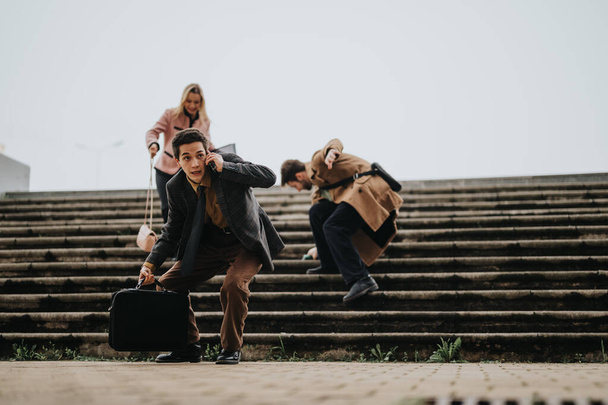 Dynamic shot of business people in motion, hurrying down outdoor stairs, showcasing active business lifestyle. - Photo, Image