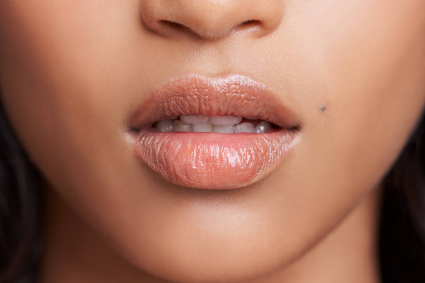 Closeup of woman, lips and skin with natural beauty, skincare and wellness with gloss for dermatology. Face, change and balm on mouth for moisturizer, cosmetic and collagen with oil or serum for glow. - Photo, Image