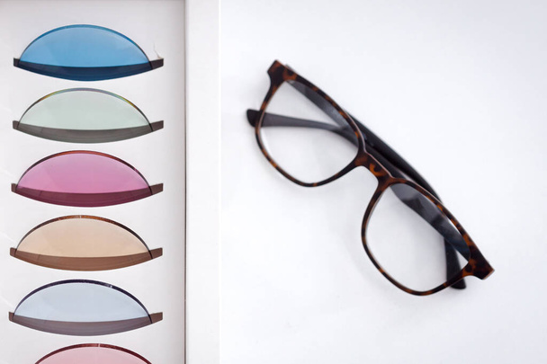 Vision bril frame in de buurt van vele kleurrijke oogheelkundige lenzen voor oogbescherming - Foto, afbeelding