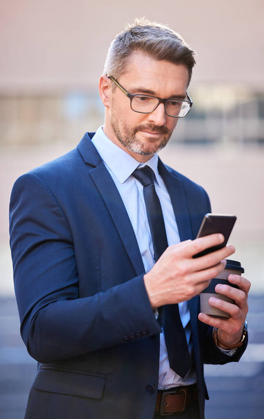 Smart, businessman and cellphone with coffee in city as property manager for company in Berlin. Male person, professional and technology for connection, communication and app in Germany in suit. - Photo, Image