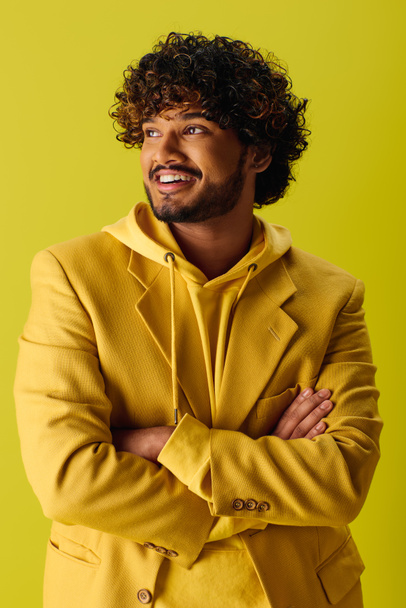 Handsome young man in yellow suit with arms crossed. - Photo, Image