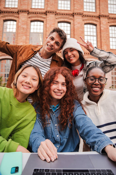 Vertical portrait of a group of friends having fun and smiling together. High school students looking at camera with happy expression. Young friendly real people staring front posing for a photo. High - Photo, Image