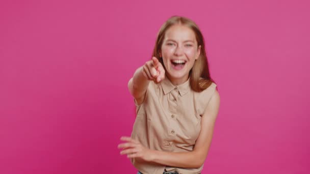 Amused lovely woman pointing finger to camera, laughing out loud, taunting making fun of ridiculous appearance, funny joke anecdote. Pretty blonde girl isolated alone on pink studio background - Footage, Video