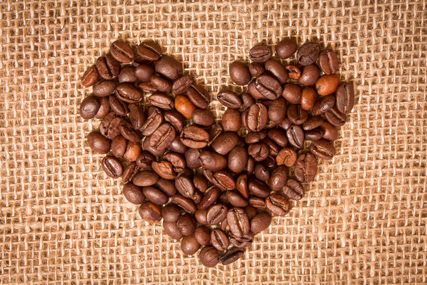 heart of coffee beans on sackcloth - Fotó, kép