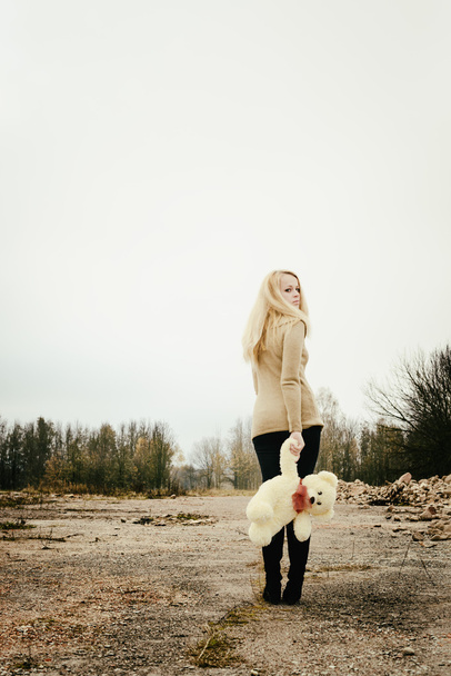 young sensual girl blonde in windy fall with toy - Fotó, kép