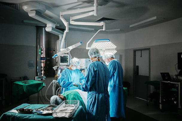 病院クリニックで緊急,事故,医療のためのチームワークを持つ外科,劇場,外科医. 手術室における手術室での軽量,医療操作,または医師による支援. - 写真・画像