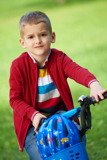 Boy on the bicycle in park - Фото, зображення