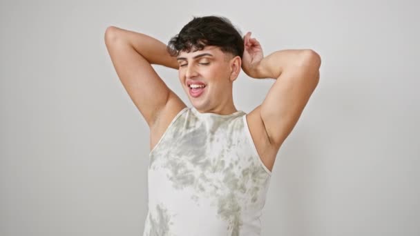 Cheerful young man in a sleeveless t-shirt playfully posing with bunny ears, a crazy fun smile lighting up his face all on an isolated white background - Footage, Video