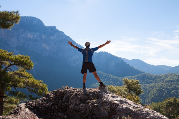 Sportsman on the top of rock. Sport and active life concept - Photo, Image