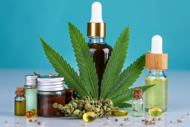 cbd oil products, hemp products and cannabis on a light blue background. - Photo, Image