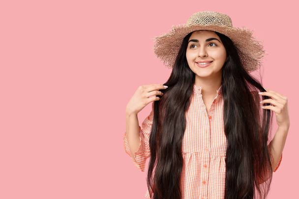 Beautiful young happy woman in straw hat on pink background. Festa Junina (June Festival) celebration - Fotografie, Obrázek
