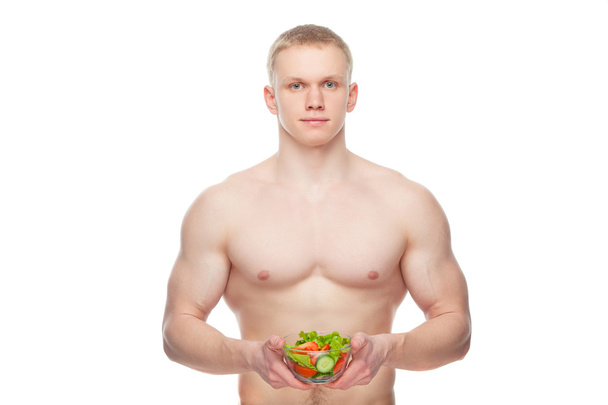 young man with a plate of vegetable salad, isolated. - Φωτογραφία, εικόνα