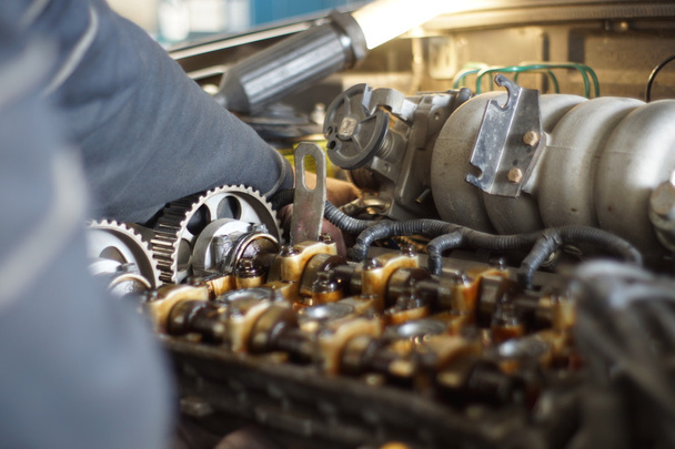 Mechanic hands tighten nut with wrench while repairing engine - Φωτογραφία, εικόνα