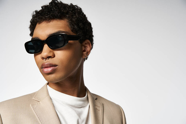Stylish young man in tan suit and sunglasses. - Photo, Image