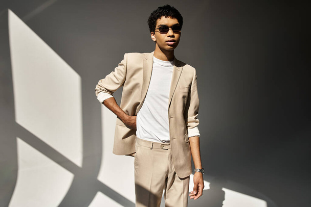Handsome African American man looking stylish in a beige suit and sunglasses. - Photo, Image