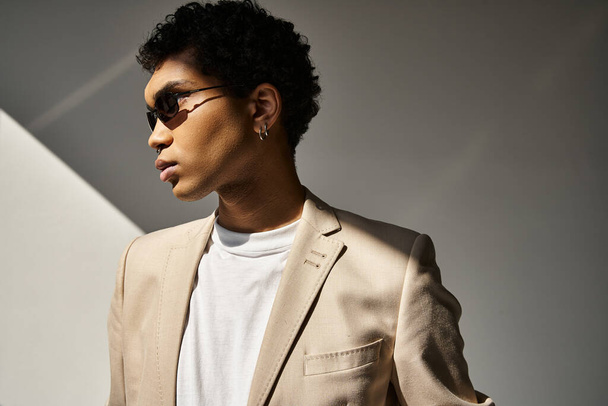 Komea afroamerikkalainen mies ruskeassa puvussa ja valkoinen paita, yllään tyylikkäät aurinkolasit. - Valokuva, kuva