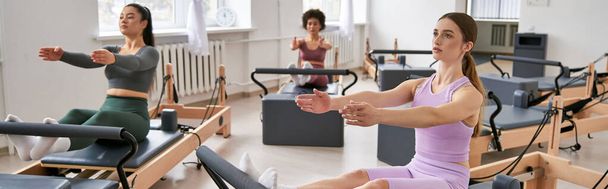 Group of women in a gym actively engaging in various exercises. - Valokuva, kuva