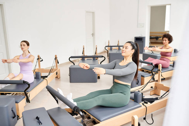 Diverse group of women performing pilates exercises in a class. - Photo, Image