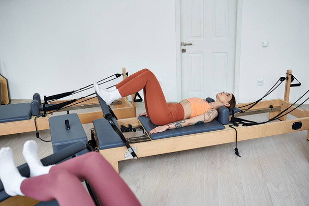 Athletic women engaging in a pilates workout at the gym. - Foto, afbeelding