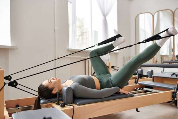 Athletic woman gracefully performs exercises during a pilates lesson. - Foto, immagini
