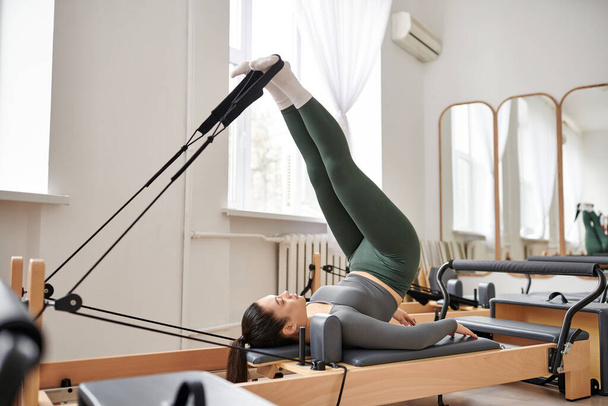Sporty woman exercises during pilates lesson. - Photo, Image