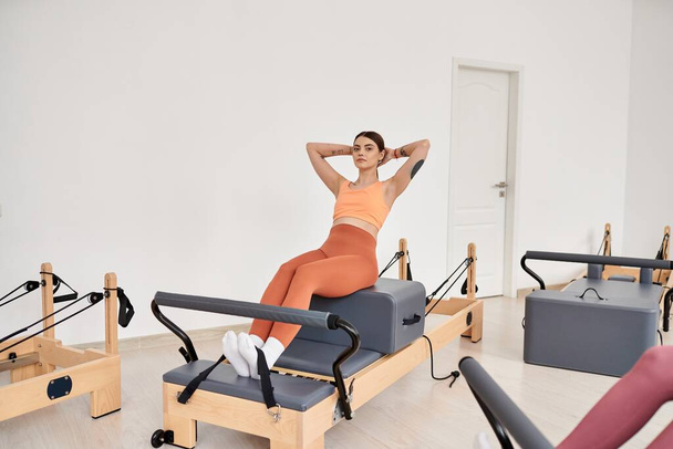 Alluring sporty woman practicing pilates with focus and determination. - Photo, Image